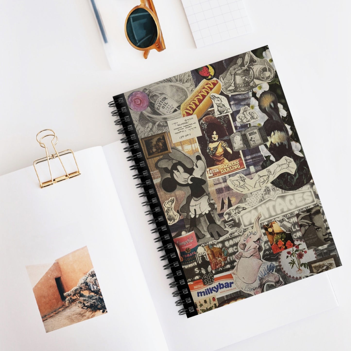 The 'Disney Darling' notebook laid on a white surface with a pen, illustrating a potential writing setup, emphasizing the notebook's use in daily life.