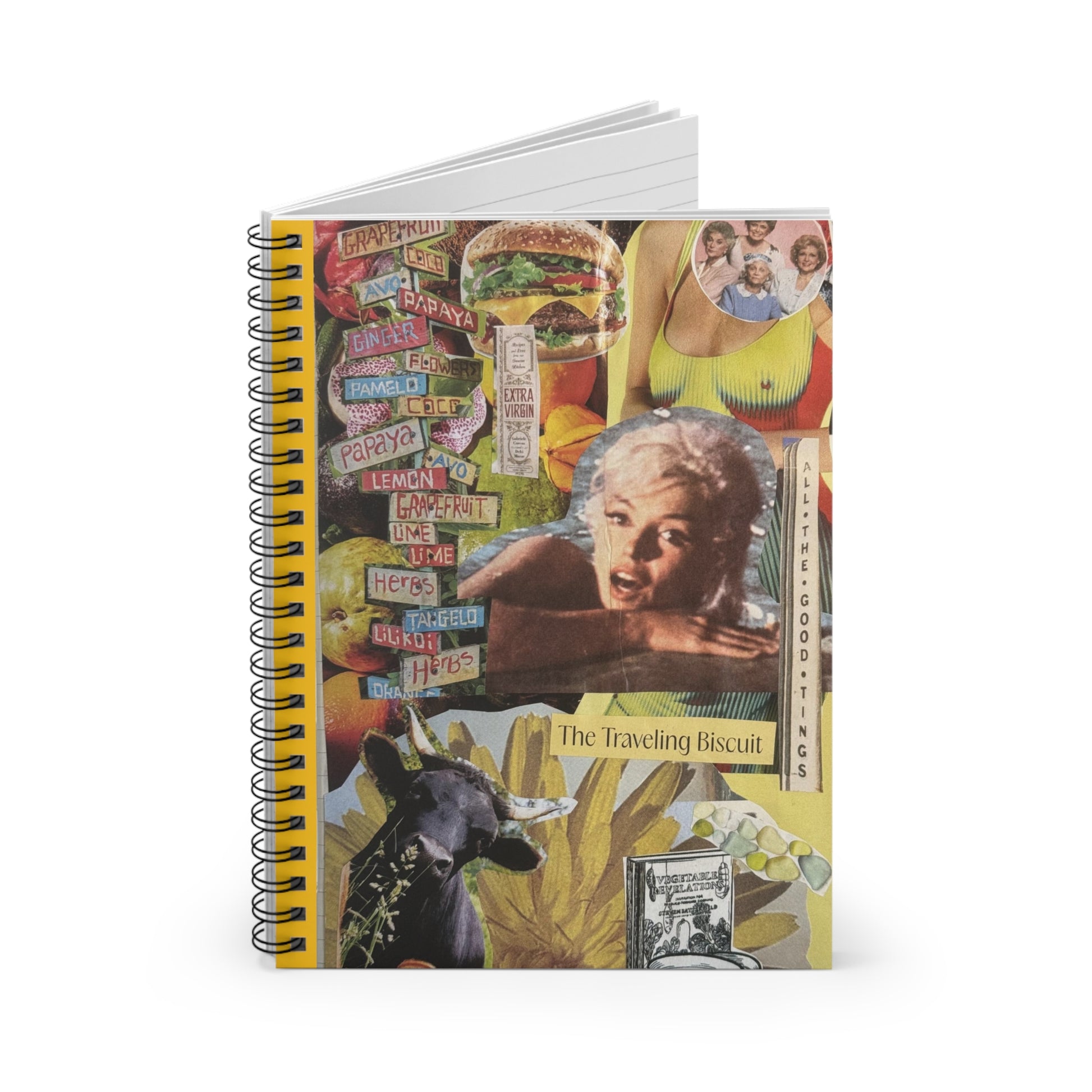 The slightly open 'All The Good Things' notebook shows the vibrant collage cover and a glimpse of lined pages for writing, with a visible metal spiral binding and a margin for page numbers or dates.